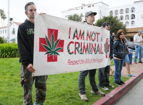 Protestors stand outside city hall before Tuesday's council meeting.